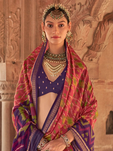 Bewitching Coral Red Patola Printed Georgette Saree With Purple Blouse